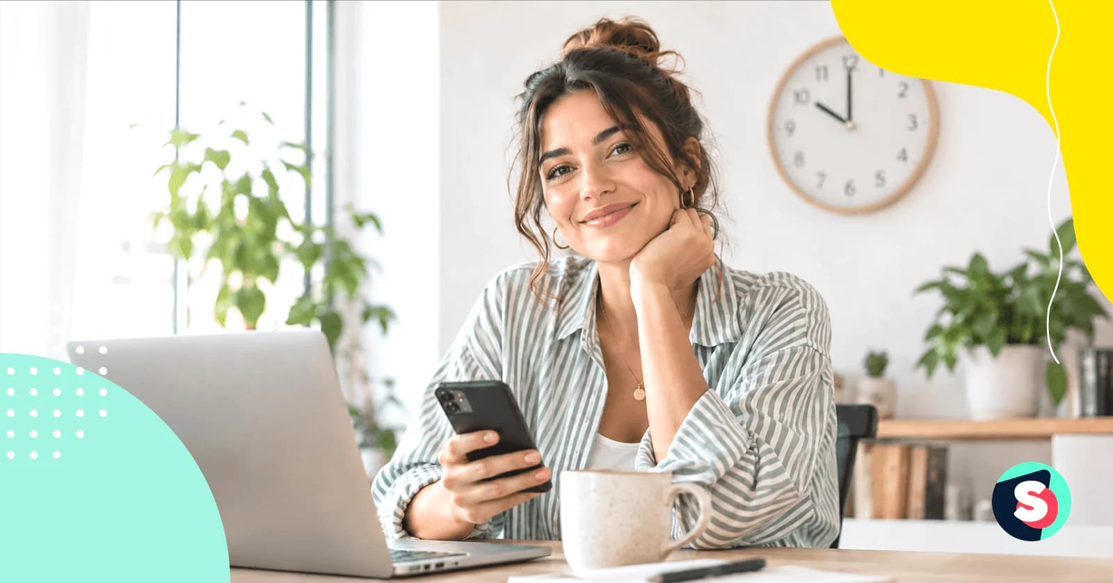 Social media manager checking her phone at a desk, planning the best time to post